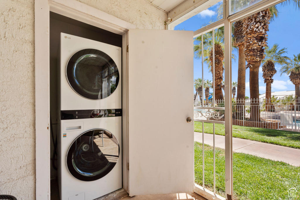 Laundry area with laundry area and stacked washer / dryer