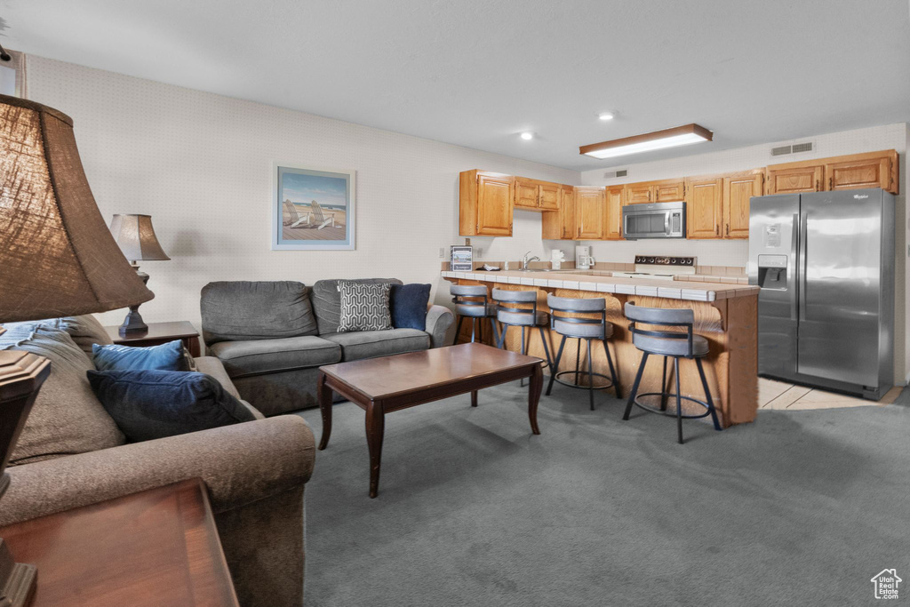 Living room with visible vents, recessed lighting, and light colored carpet