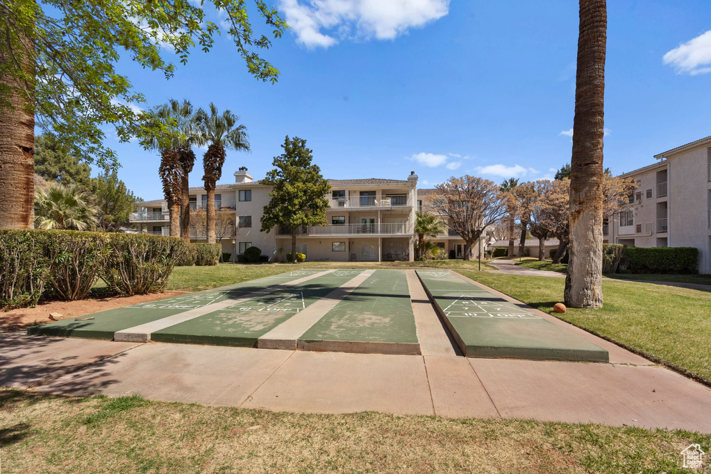 Surrounding community with a residential view, a yard, and shuffleboard