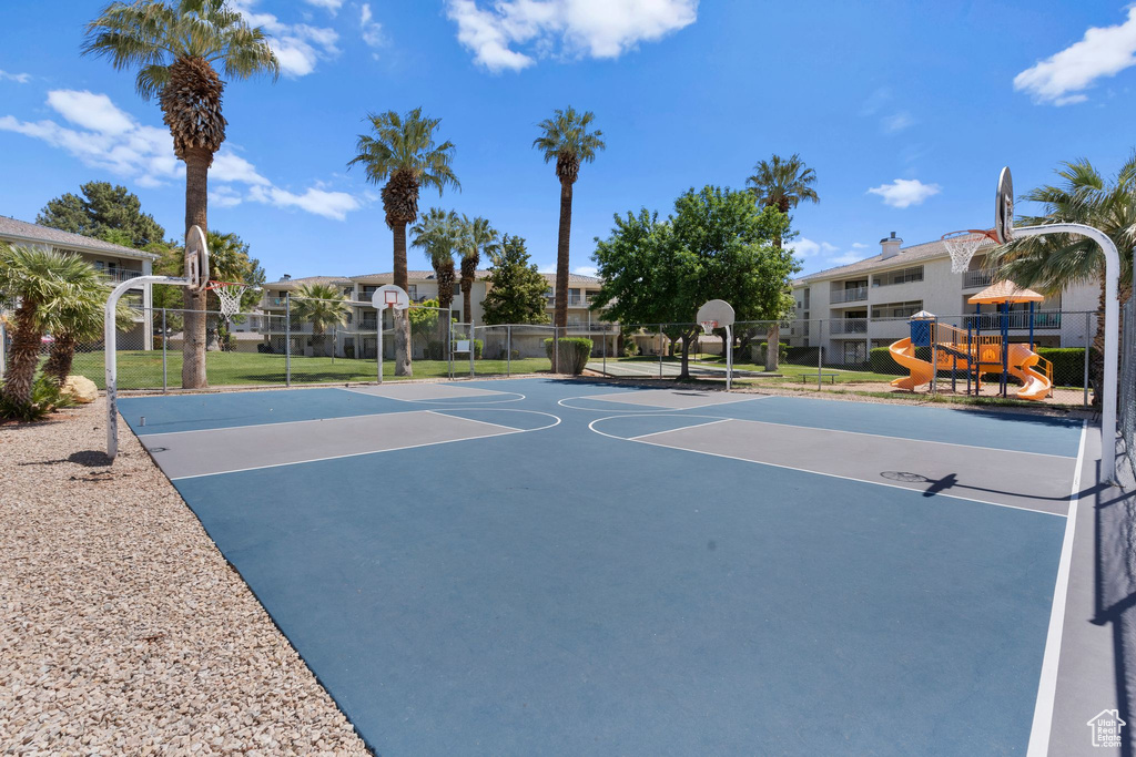 View of basketball court featuring community basketball court, fence, and playground community
