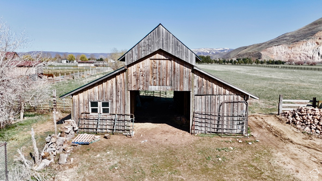 View of barn with a rural view and a mountain view