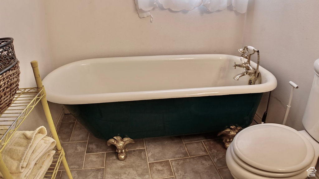 Bathroom featuring toilet and a freestanding bath