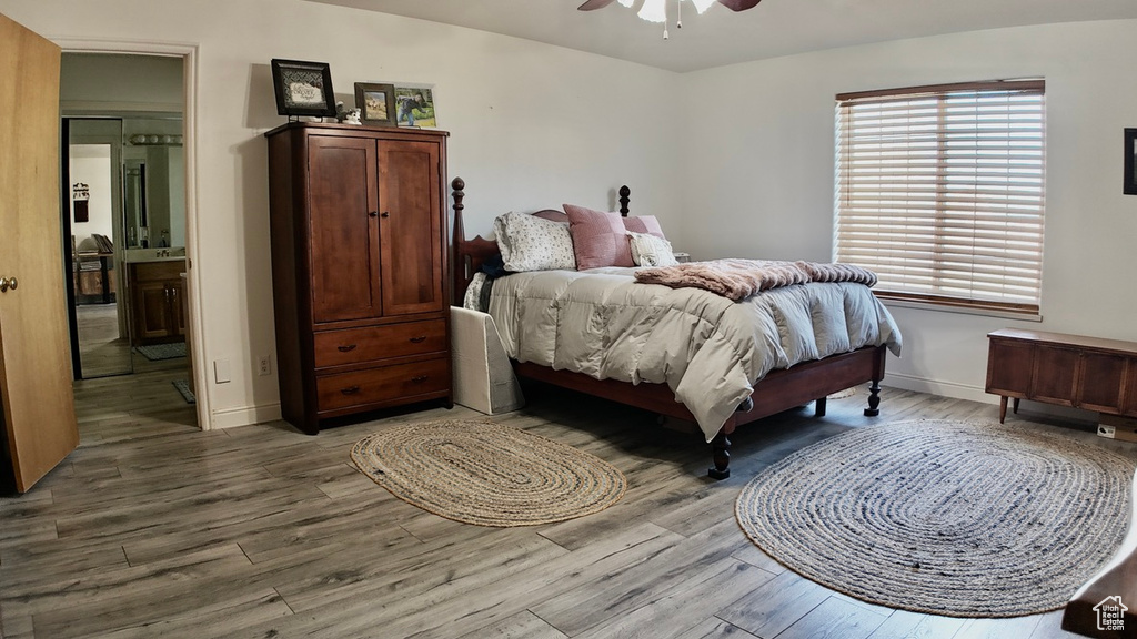 Bedroom with ceiling fan, baseboards, and wood finished floors