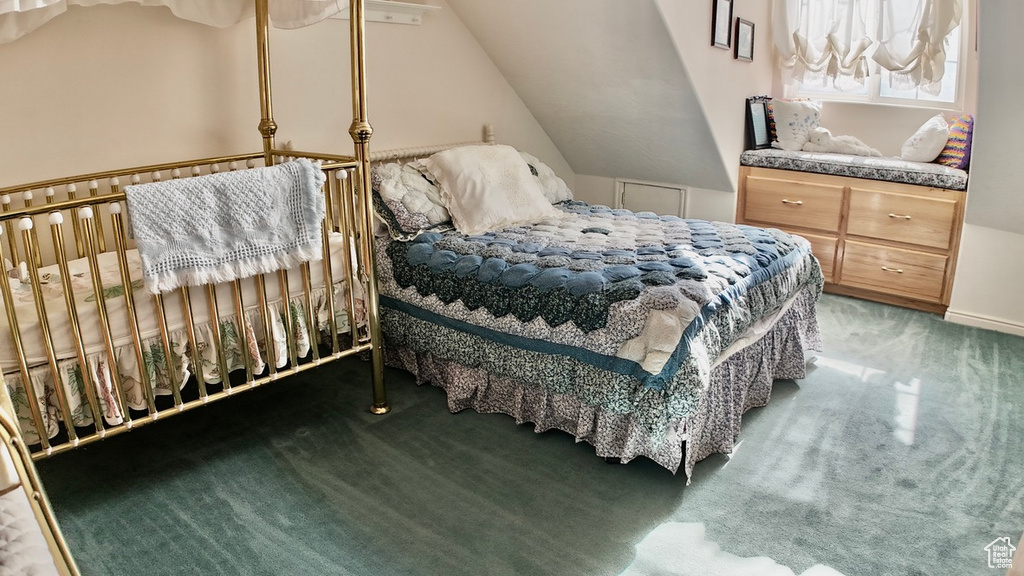 Carpeted bedroom with lofted ceiling