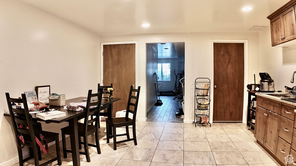 Dining area with baseboards and recessed lighting