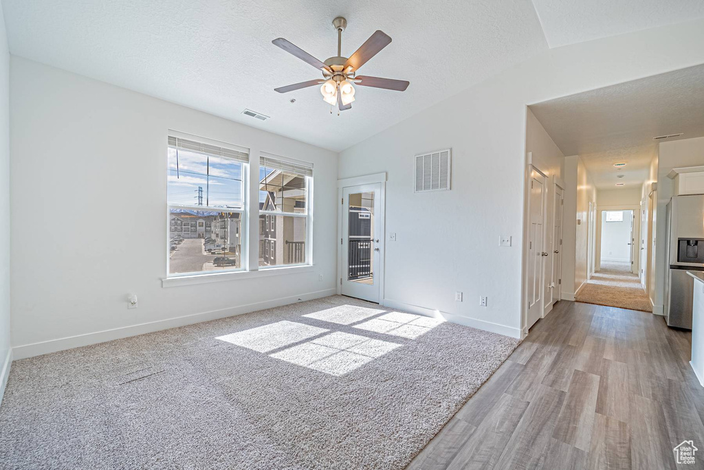 Spare room featuring baseboards, visible vents, and a wealth of natural light