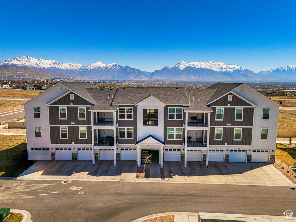 View of front of house with board and batten siding, a mountain view, and an attached garage