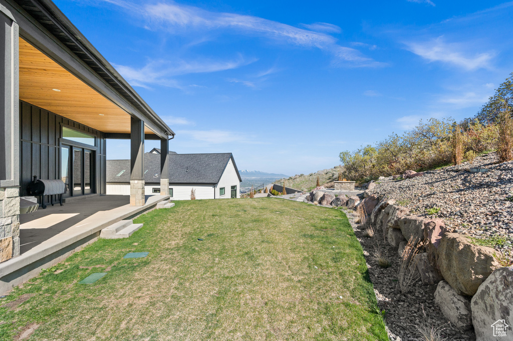 View of yard with a patio and a mountain view