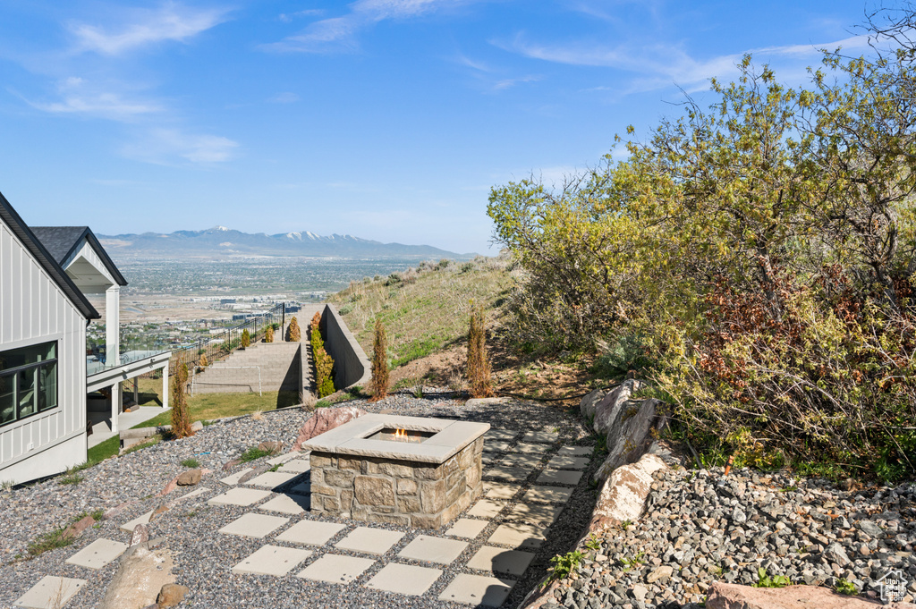 View of patio / terrace with a mountain view and an outdoor fire pit