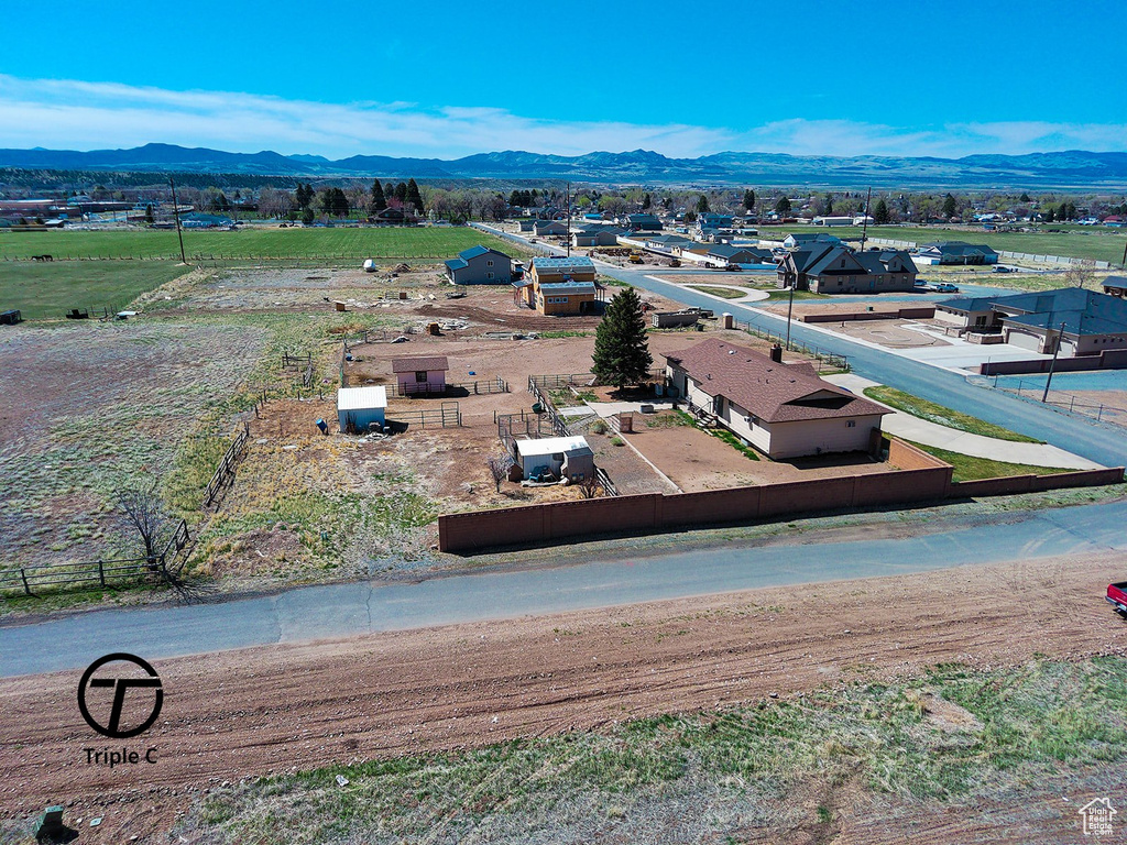 Birds eye view of property with a mountain view and a rural view