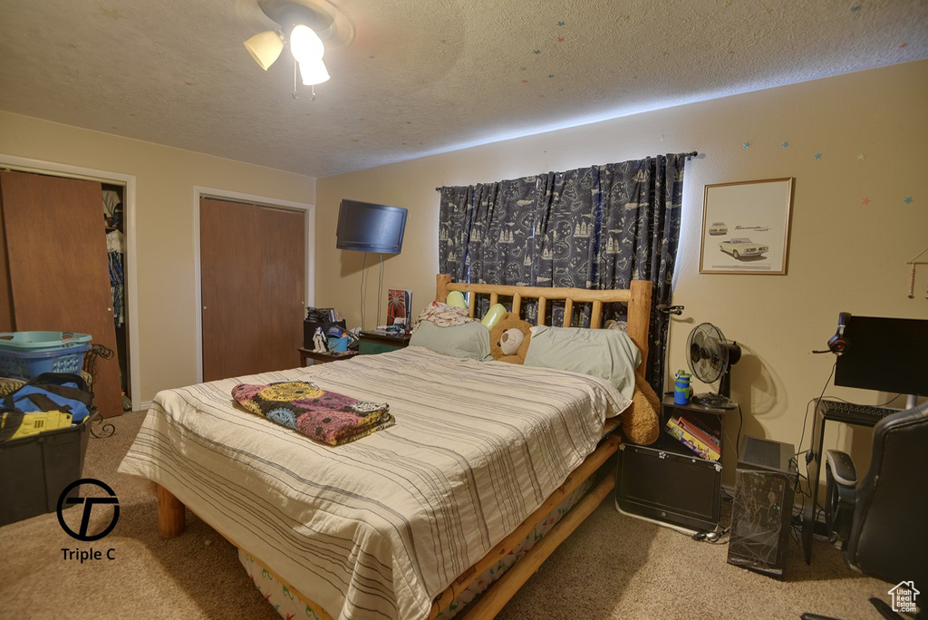 Carpeted bedroom featuring a textured ceiling
