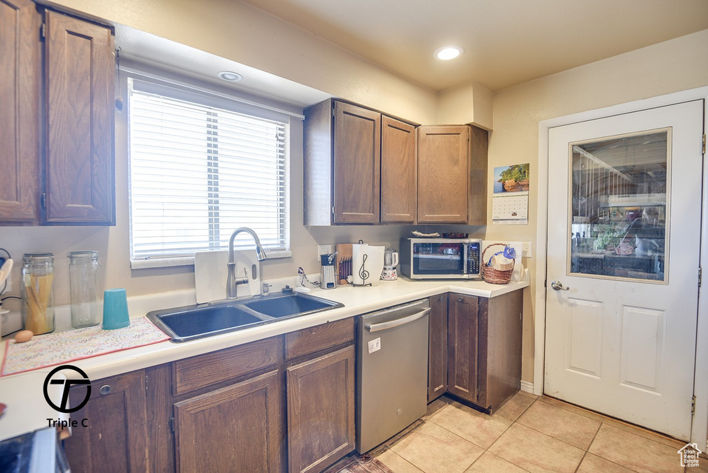 Kitchen featuring light tile patterned floors, recessed lighting, appliances with stainless steel finishes, light countertops, and a sink