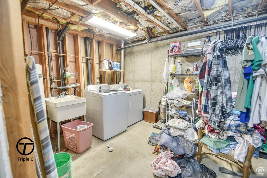 Unfinished basement featuring independent washer and dryer and a sink