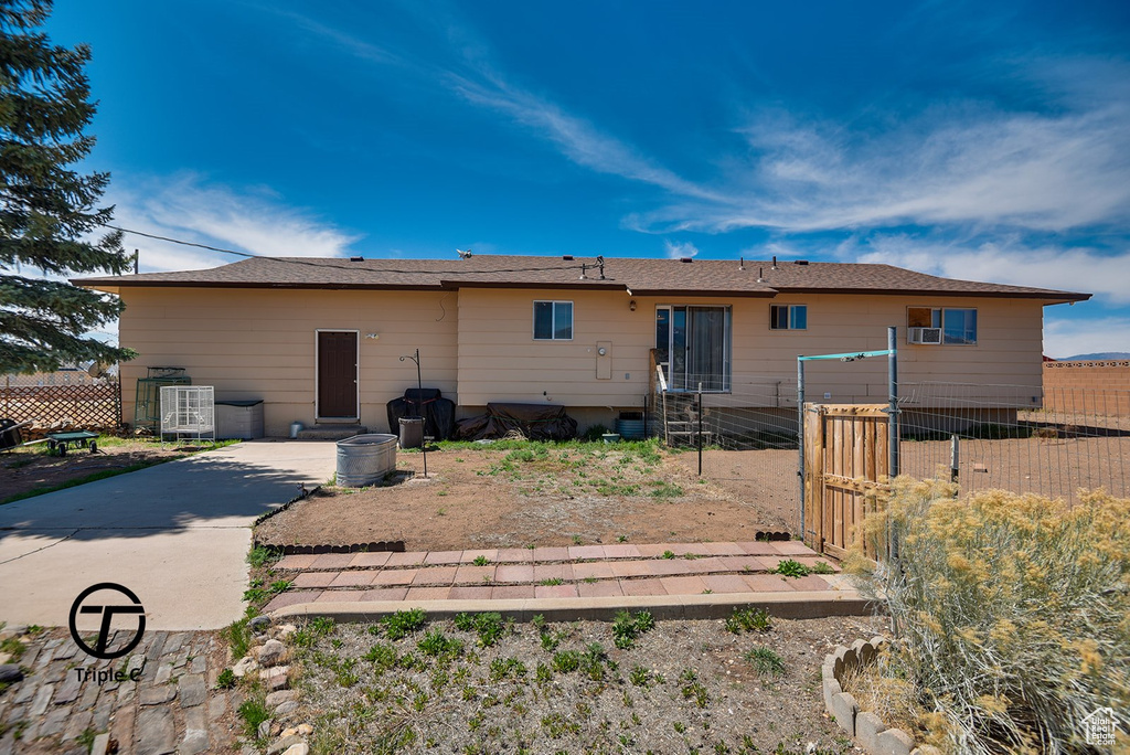 Rear view of property with fence and a gate