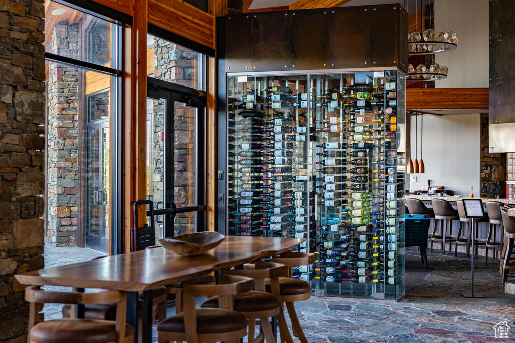 Wine area featuring a towering ceiling and stone flooring