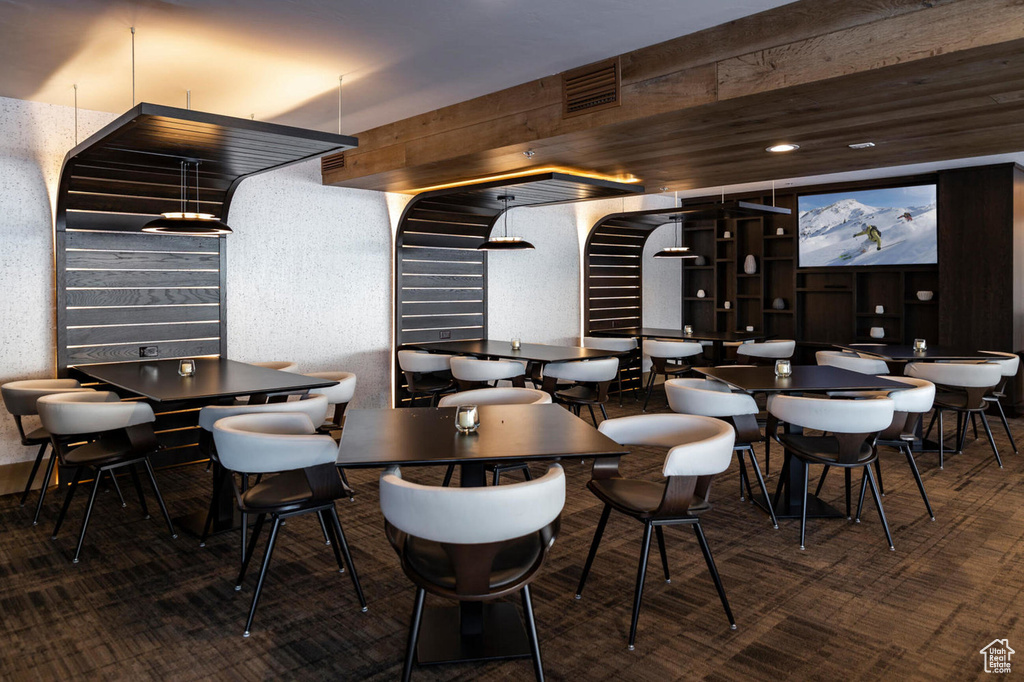Dining space featuring visible vents and carpet floors