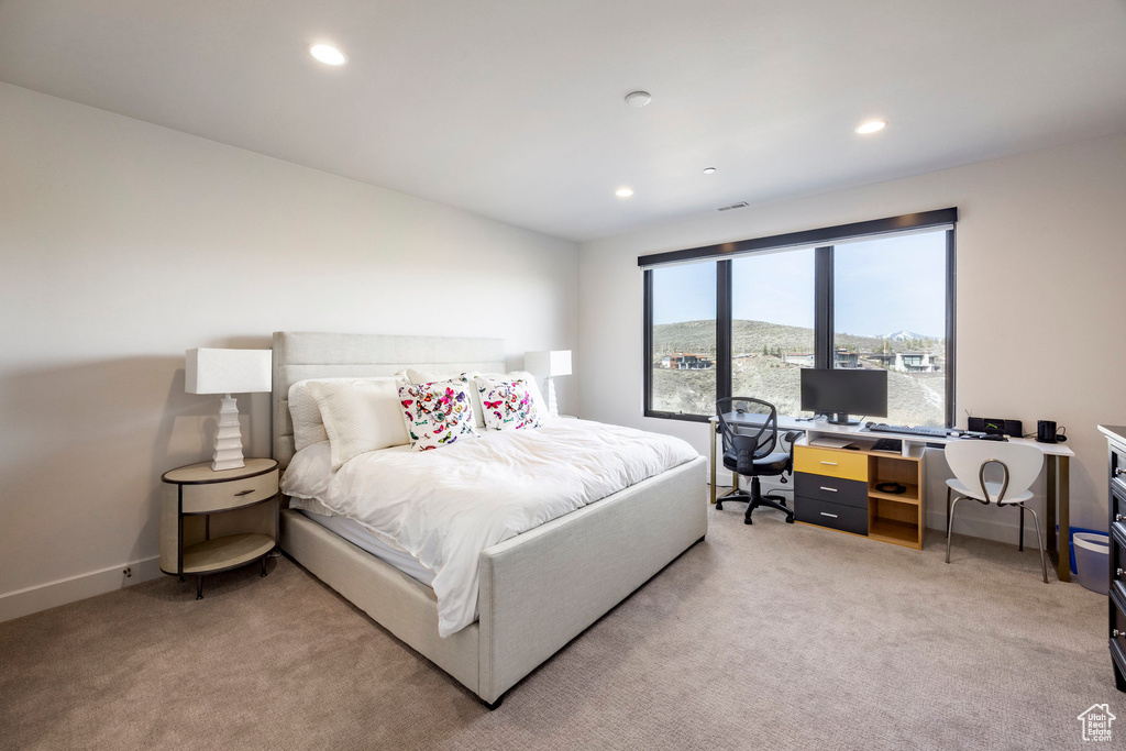 Bedroom with light carpet and recessed lighting