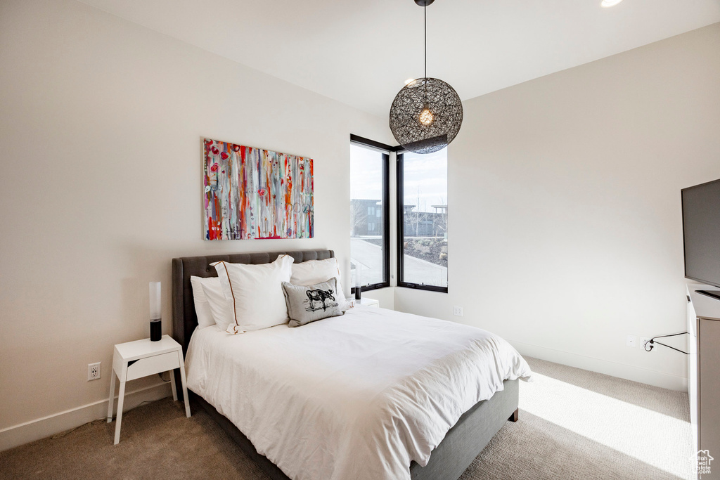 Bedroom featuring baseboards and carpet