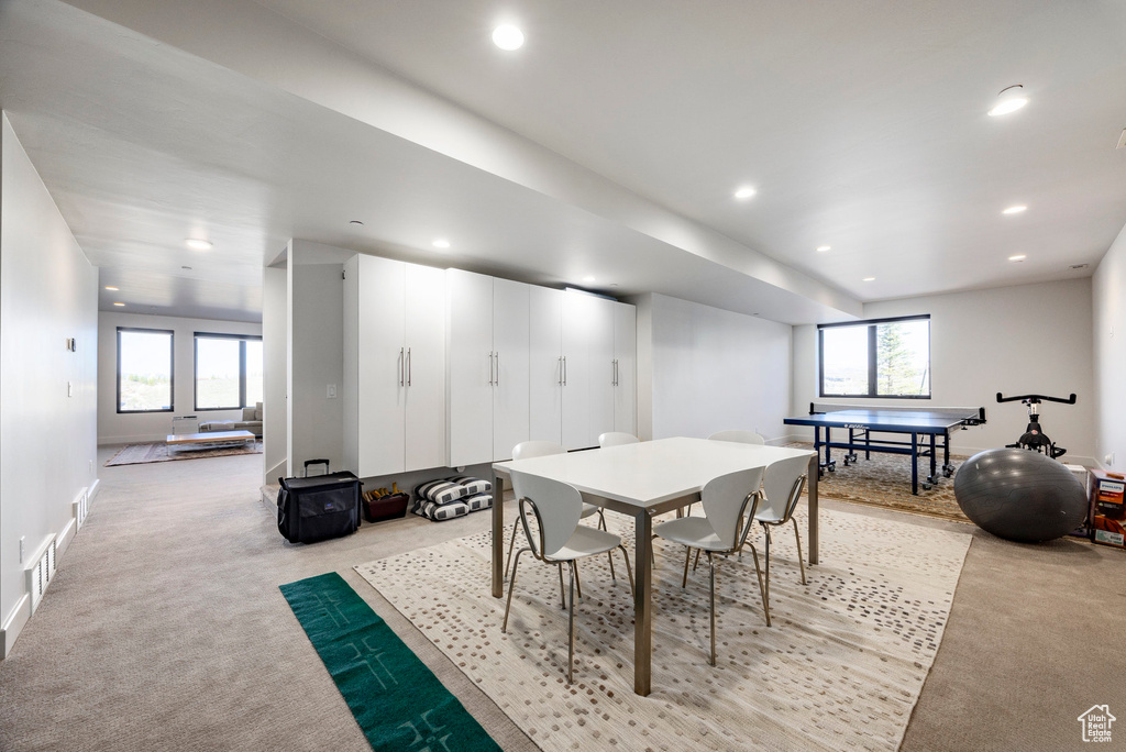 Dining room featuring recessed lighting, light colored carpet, and baseboards