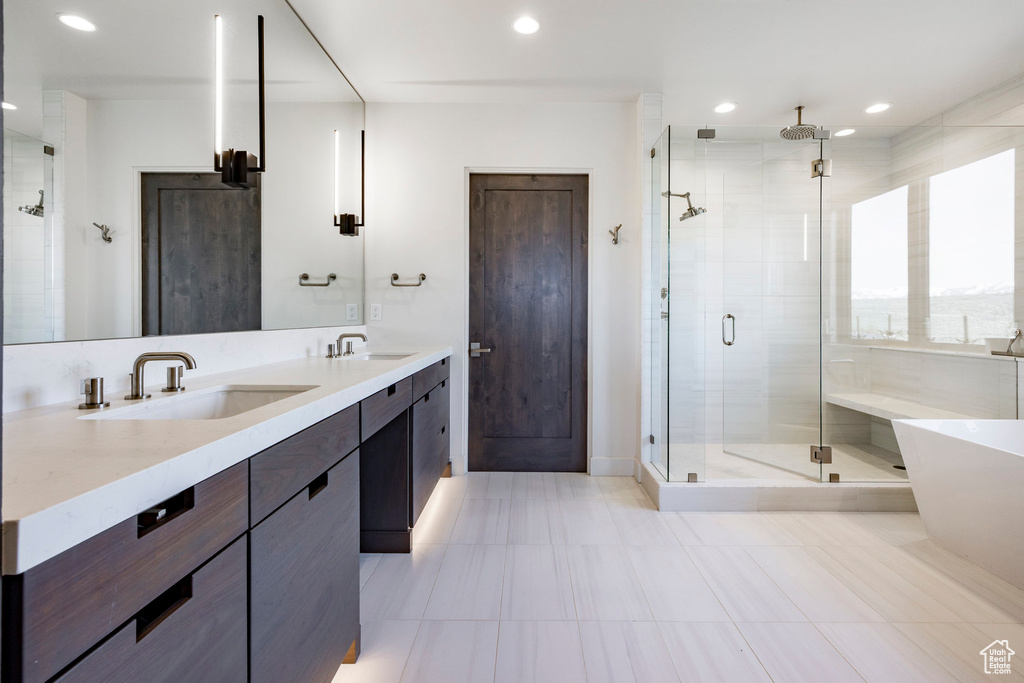 Full bathroom featuring a sink, a shower stall, double vanity, and recessed lighting
