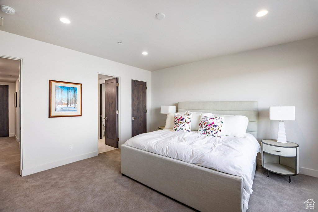 Carpeted bedroom with baseboards and recessed lighting