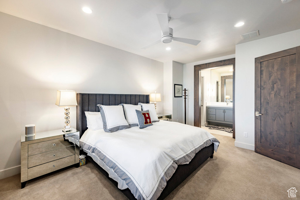 Bedroom featuring visible vents, baseboards, ensuite bathroom, recessed lighting, and light colored carpet