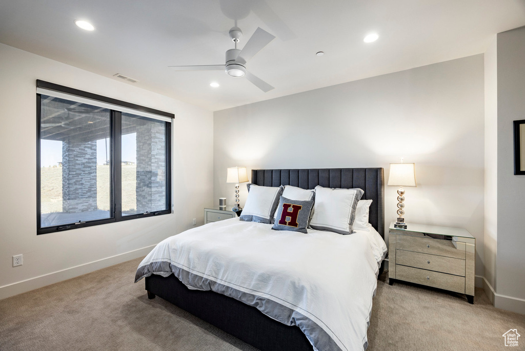 Bedroom featuring light carpet, baseboards, and visible vents