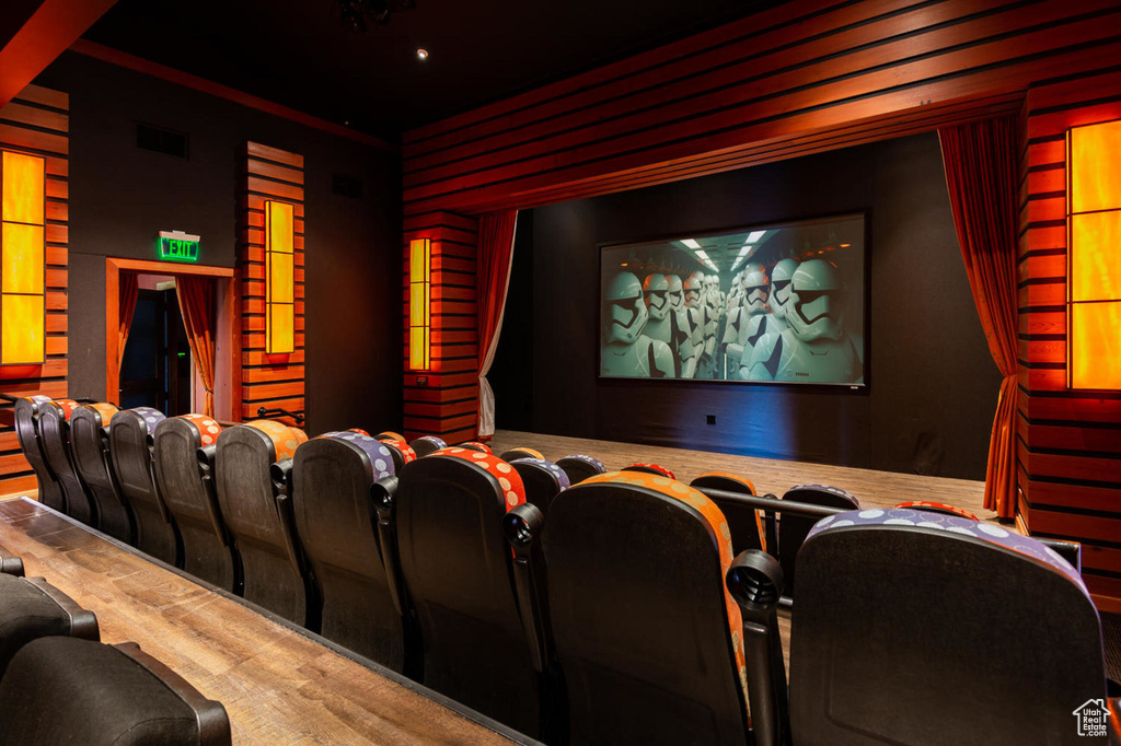 Home theater room with wood finished floors, visible vents, and recessed lighting