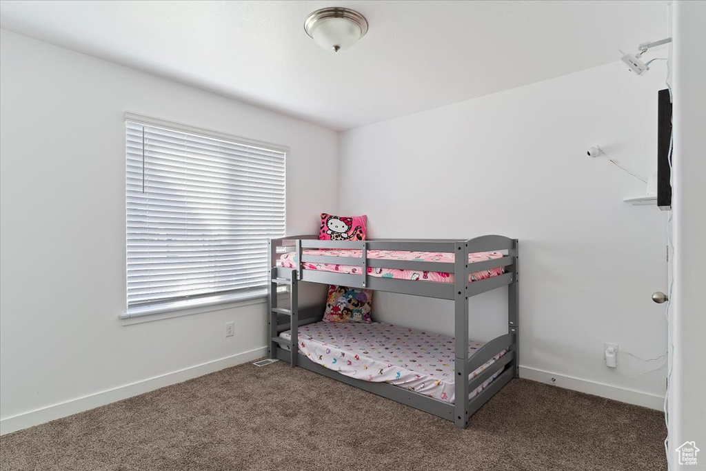 Bedroom with carpet flooring and baseboards