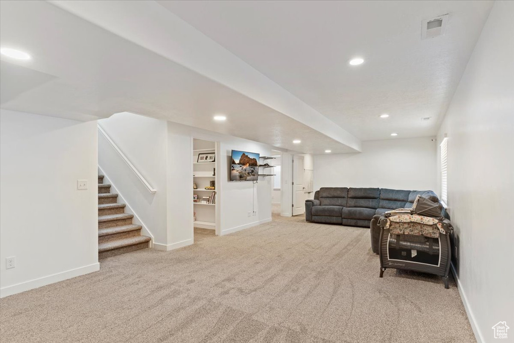 Carpeted living room featuring recessed lighting, stairway, and baseboards