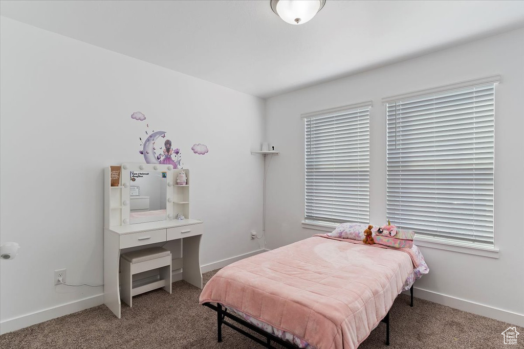 Bedroom featuring baseboards and carpet