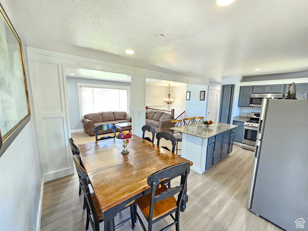 Dining room featuring light wood-style flooring and recessed lighting