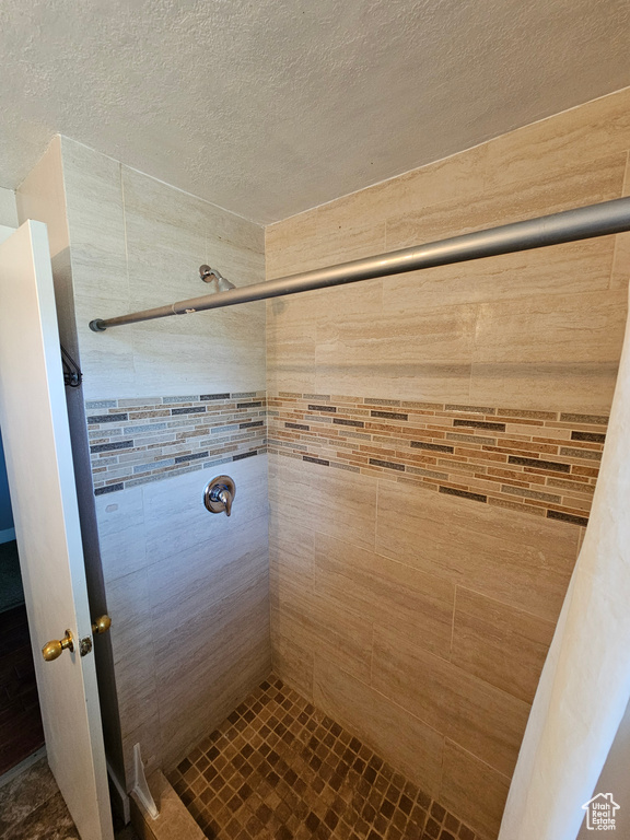 Full bathroom with a stall shower and a textured ceiling