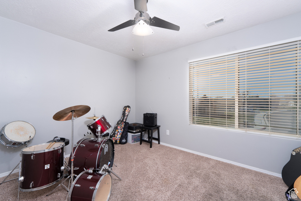 Miscellaneous room with visible vents, ceiling fan, carpet floors, and baseboards