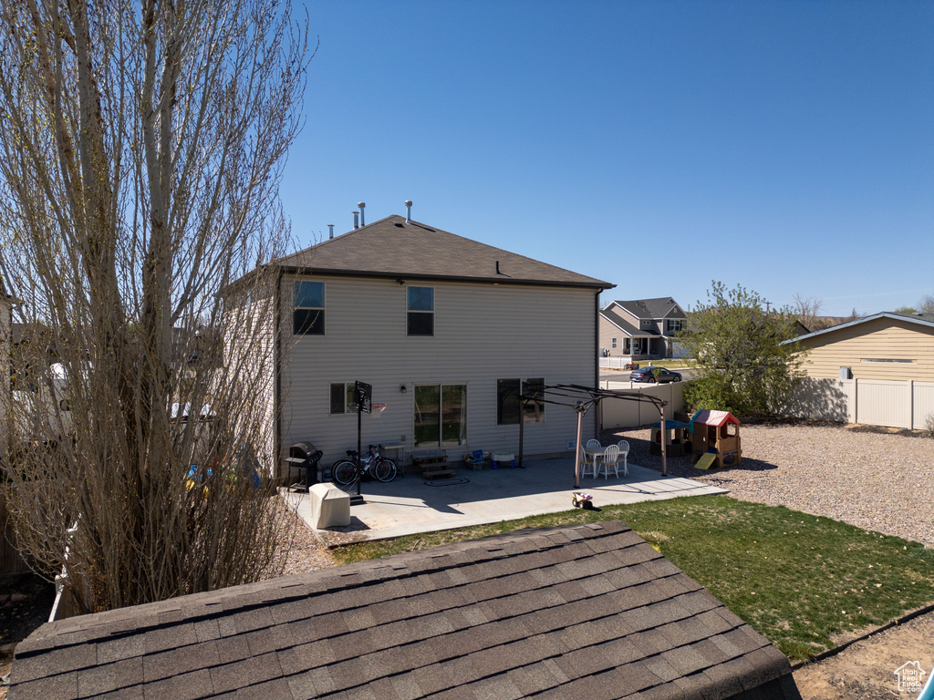 Rear view of property with a patio area and fence