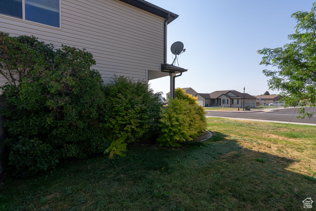 View of green lawn featuring a residential view