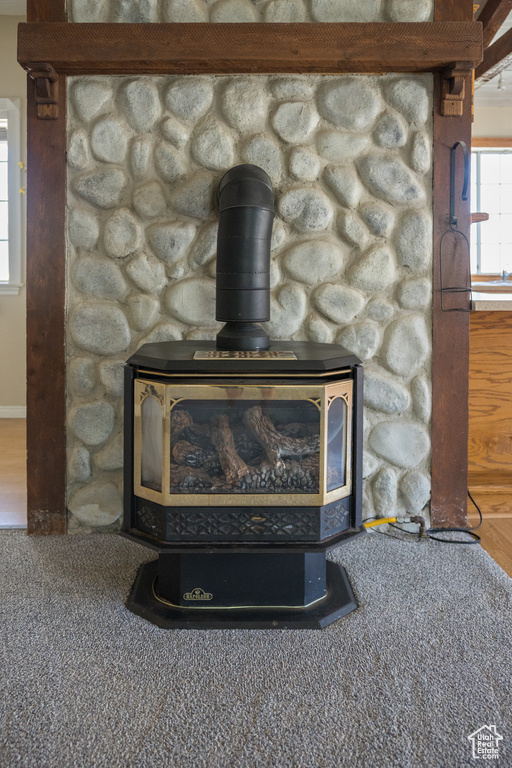 Interior details featuring a wood stove and carpet floors