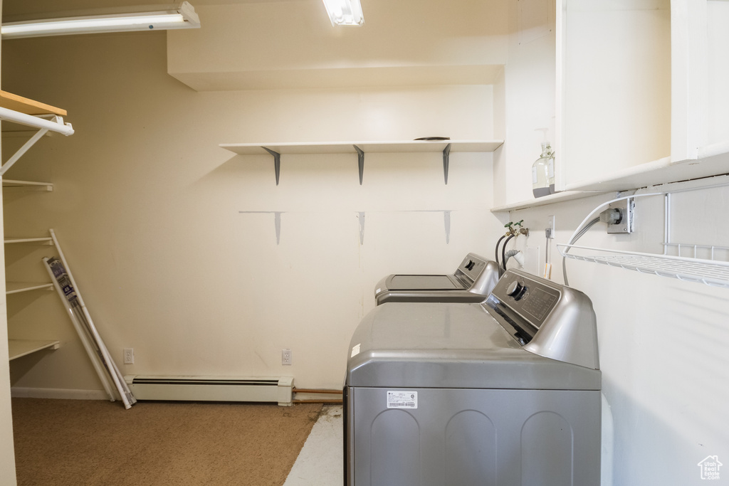 Washroom featuring independent washer and dryer, carpet, laundry area, and baseboard heating