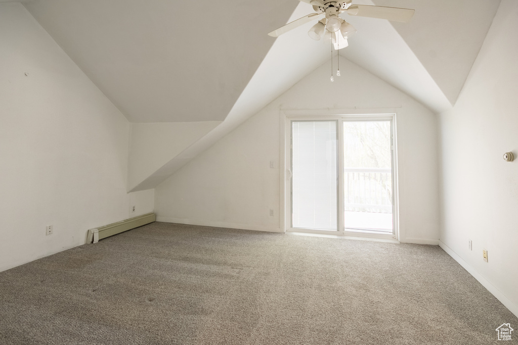 Bonus room featuring a baseboard radiator, ceiling fan, carpet, and lofted ceiling