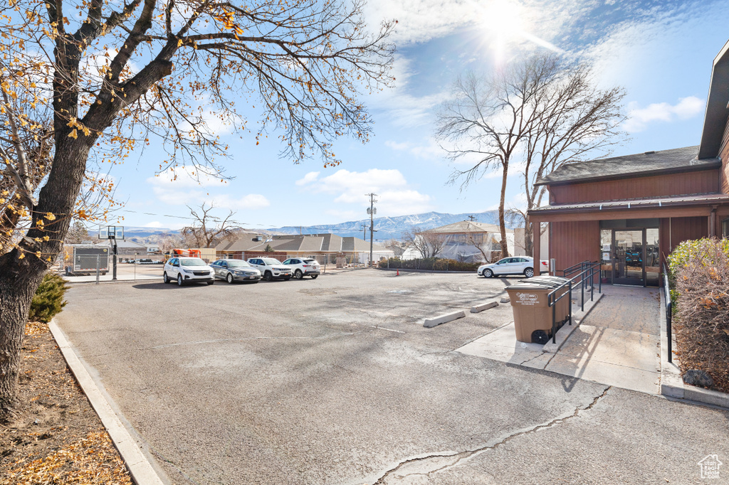 Uncovered parking lot featuring a mountain view
