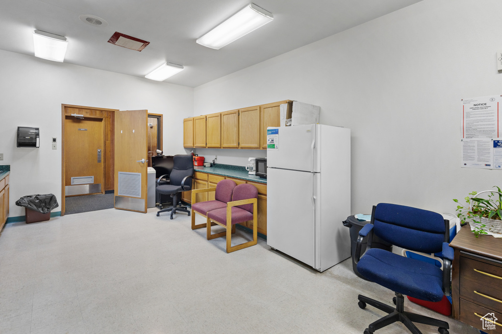 Home office featuring light carpet and visible vents