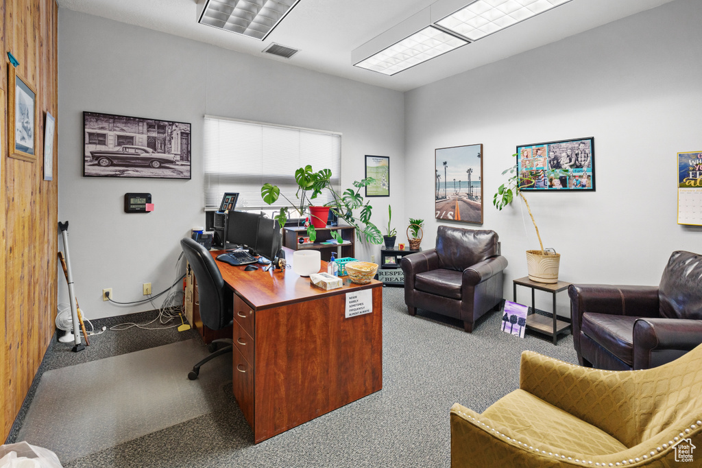 Home office featuring dark carpet and visible vents