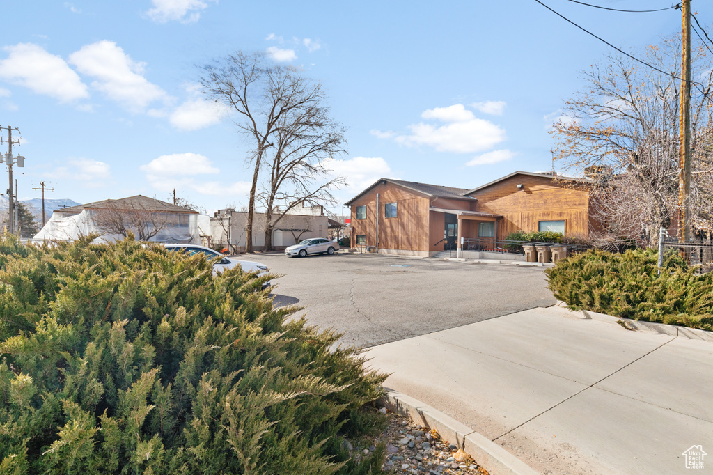 Exterior space featuring uncovered parking and fence