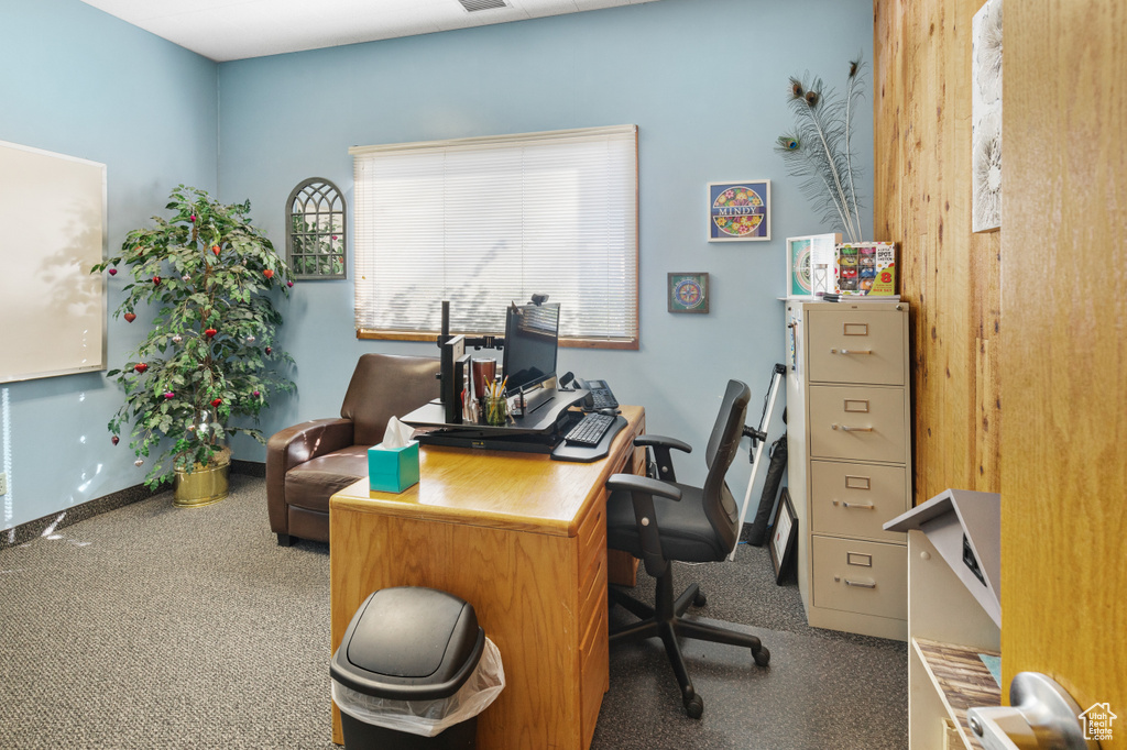 Home office with baseboards, visible vents, and carpet floors