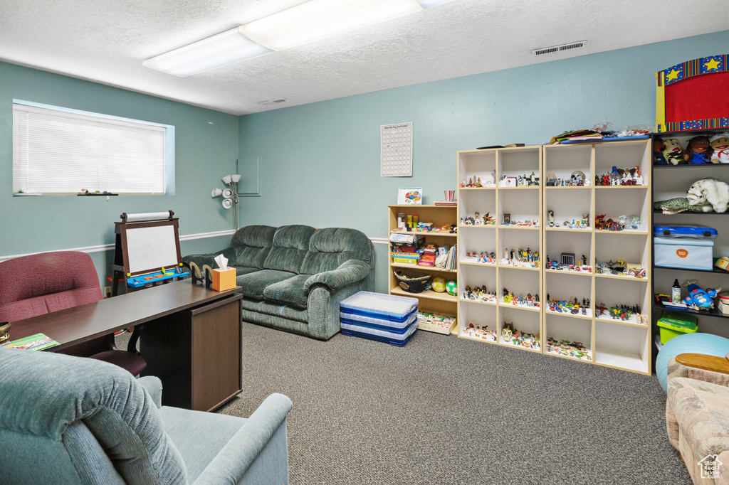 Interior space with a textured ceiling and visible vents
