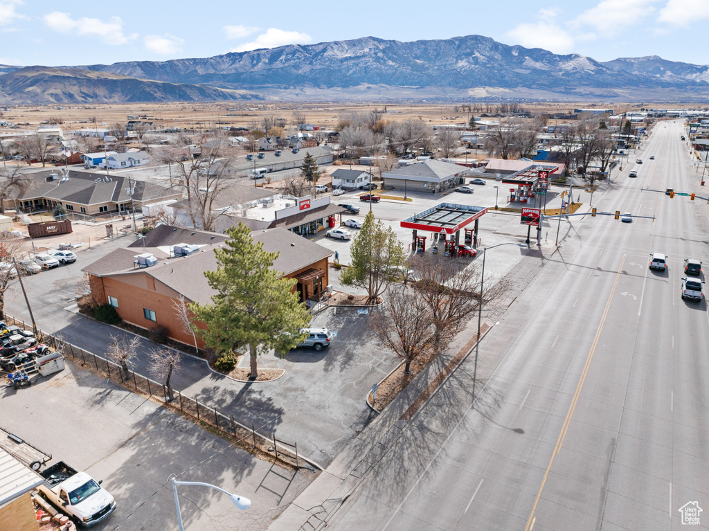 Birds eye view of property with a mountain view and a residential view