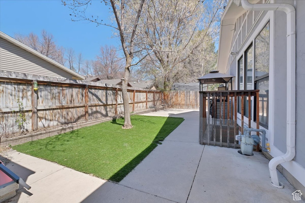 View of yard featuring a patio and a fenced backyard
