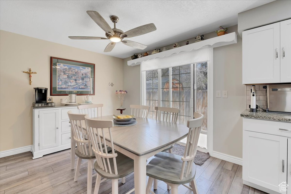 Dining space featuring light wood finished floors, baseboards, and ceiling fan