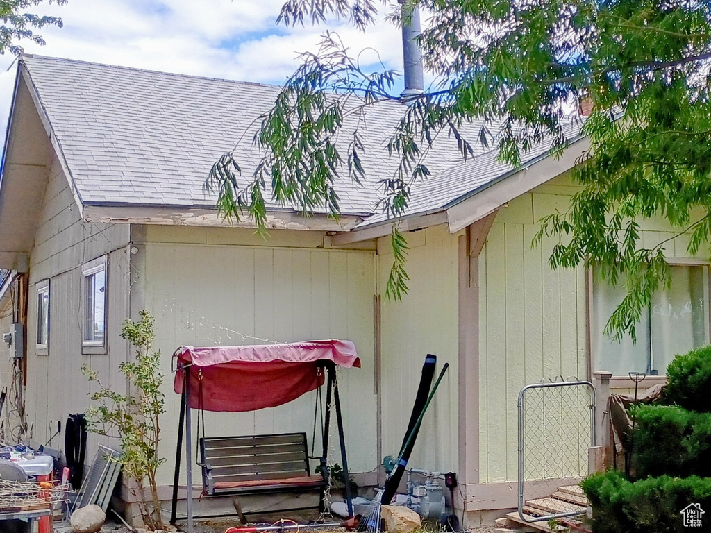 View of front of property featuring roof with shingles and entry steps