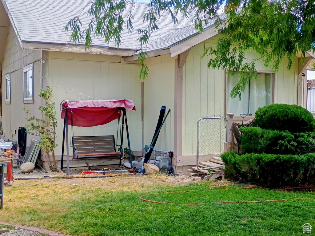 View of property exterior with a shingled roof
